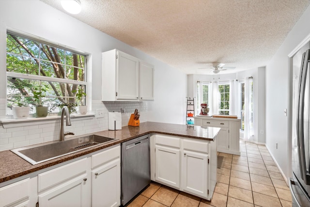 1227 Ocean View Rd, Charleston, SC 29412 - kitchen with appliances with stainless steel finishes, a sink, a peninsula, backsplash, and plenty of natural light
