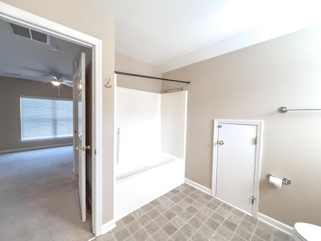 full bath with ceiling fan, bathtub / shower combination, toilet, and baseboards