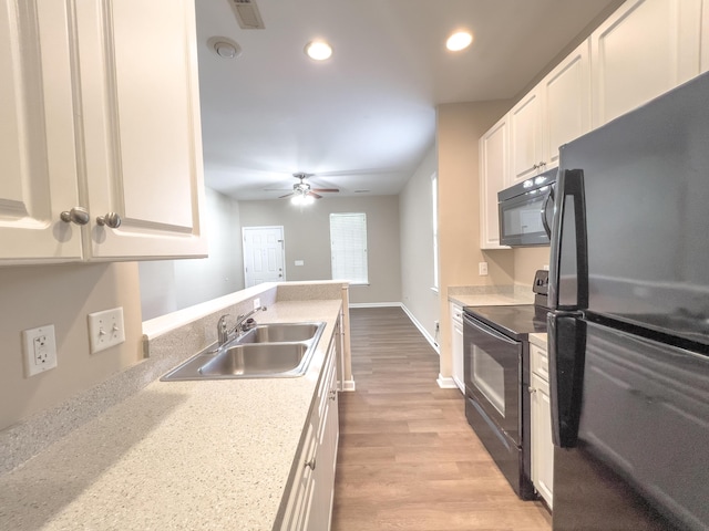kitchen featuring black appliances, a sink, light countertops, white cabinetry, and ceiling fan