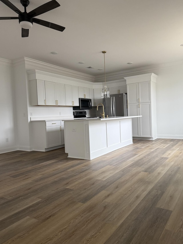 kitchen featuring stainless steel appliances, white cabinets, light countertops, and an island with sink