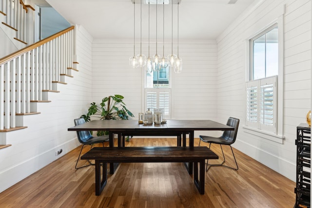 dining space with hardwood / wood-style floors and a healthy amount of sunlight