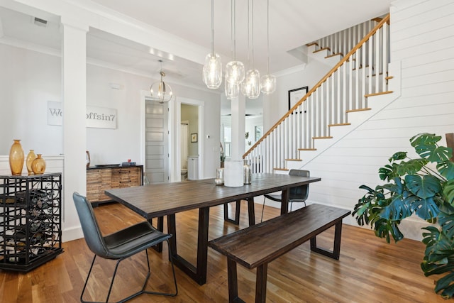 dining space featuring crown molding and wood-type flooring