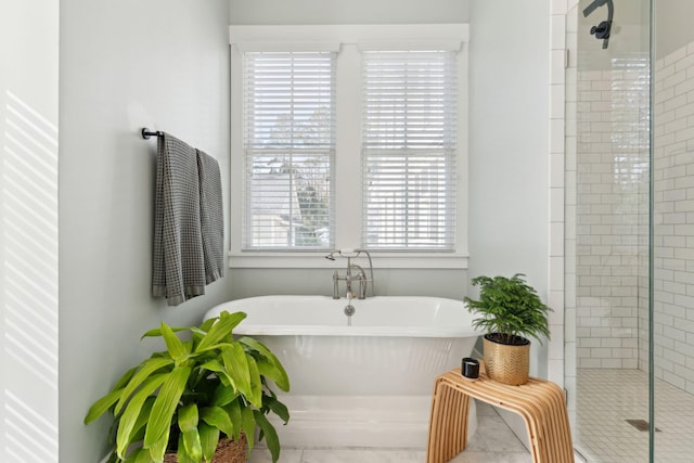 bathroom featuring independent shower and bath and plenty of natural light