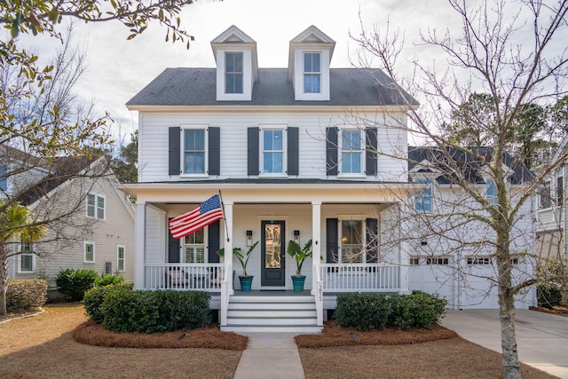 view of front of house with a porch and a garage