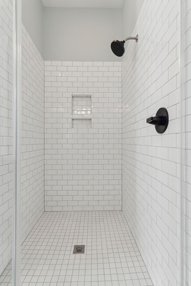 bathroom with a tile shower