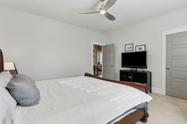 bedroom with ceiling fan and light carpet