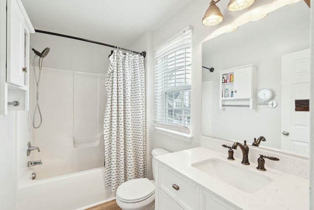 full bath featuring toilet, shower / tub combo with curtain, and vanity