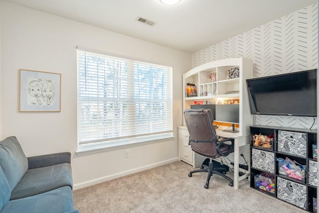 home office with light carpet, baseboards, and visible vents