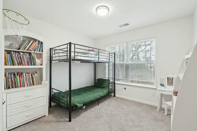 carpeted bedroom with baseboards and visible vents