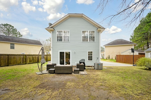 back of property featuring a lawn, cooling unit, a fenced backyard, and an outdoor living space