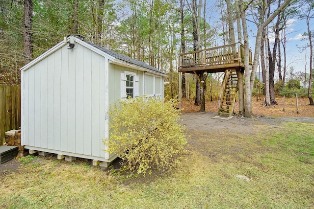 view of outdoor structure with stairs, an outdoor structure, and fence