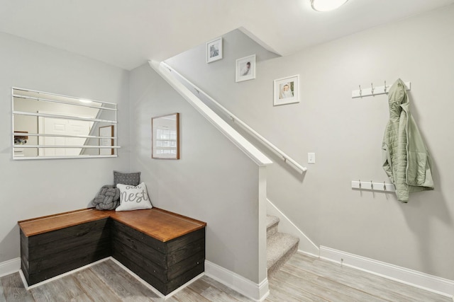 stairs featuring baseboards and wood finished floors