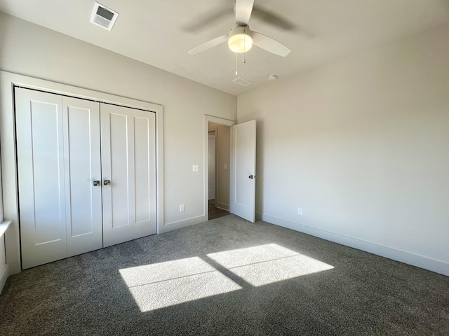 unfurnished bedroom featuring ceiling fan, visible vents, baseboards, a closet, and carpet