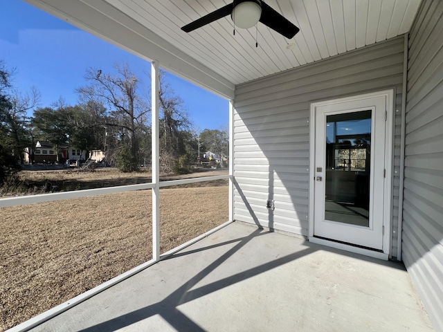 unfurnished sunroom with a ceiling fan