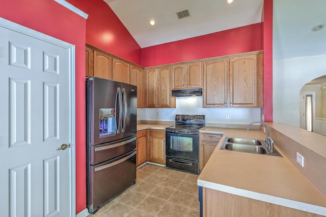 kitchen featuring visible vents, stainless steel fridge, a sink, under cabinet range hood, and black range with electric stovetop