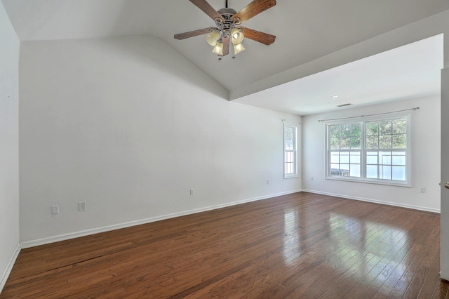 empty room featuring baseboards, vaulted ceiling, a ceiling fan, and dark wood finished floors
