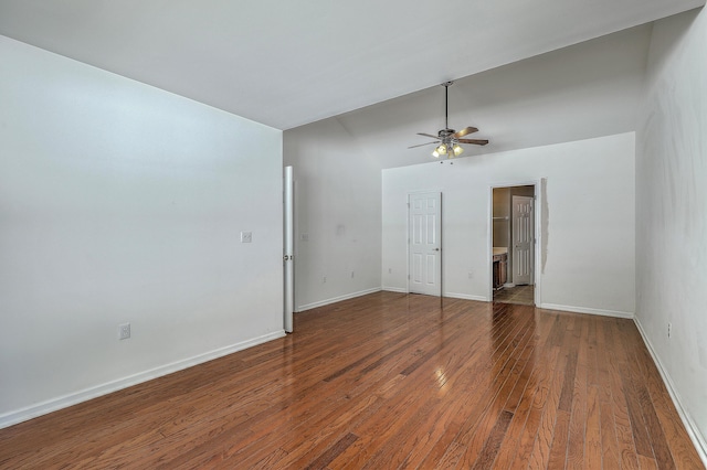 spare room featuring baseboards, a ceiling fan, wood finished floors, and lofted ceiling