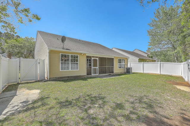 rear view of property with a fenced backyard, cooling unit, a gate, and a lawn