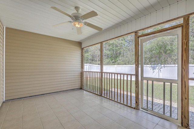 unfurnished sunroom featuring ceiling fan