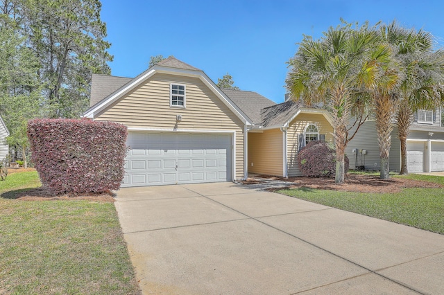 view of front of property with roof with shingles, concrete driveway, a garage, and a front yard