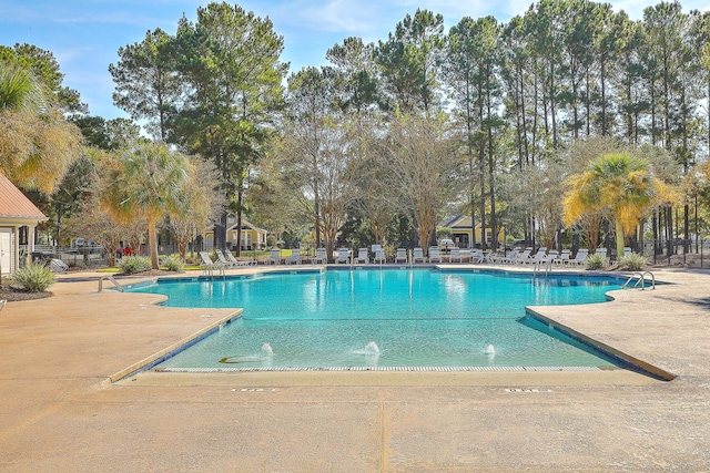 community pool featuring a patio area and fence