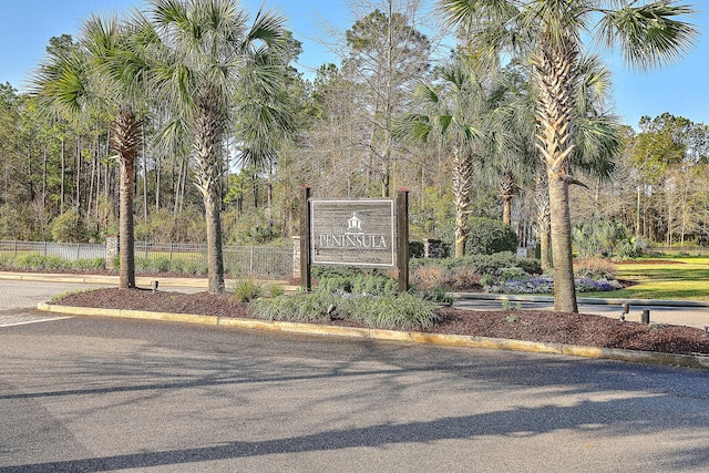 community / neighborhood sign featuring fence