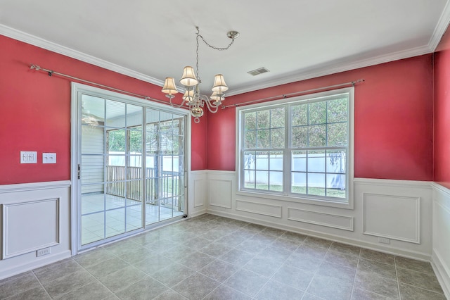 unfurnished dining area featuring crown molding, a decorative wall, visible vents, a wainscoted wall, and a notable chandelier