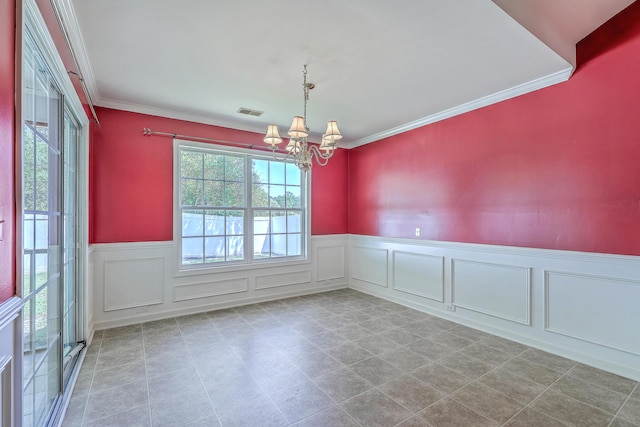 spare room with a decorative wall, visible vents, a notable chandelier, and wainscoting