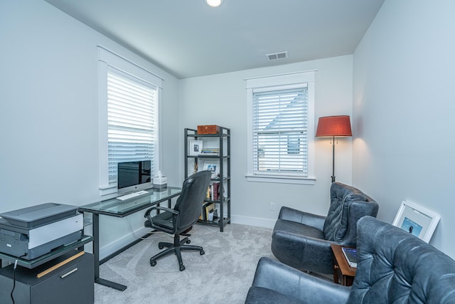 home office with a wealth of natural light and light colored carpet