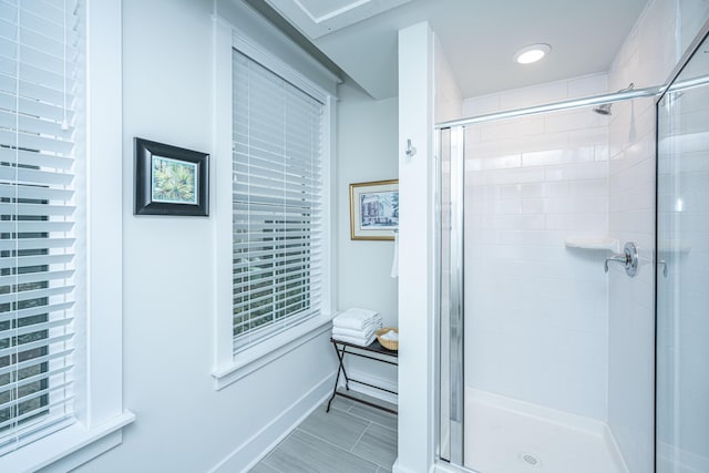 bathroom with a shower with door