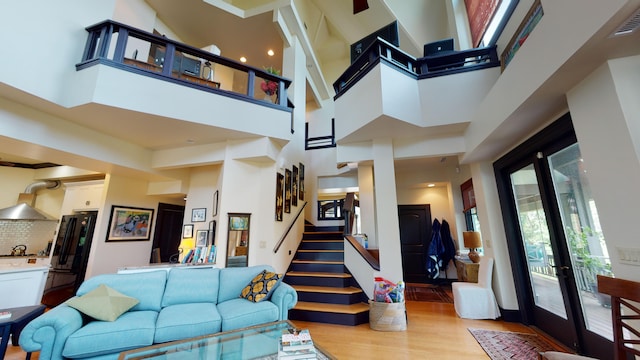 268 Little Oak Island Dr, Folly Beach, SC 29439 - interior space featuring light hardwood / wood-style floors, a high ceiling, and french doors