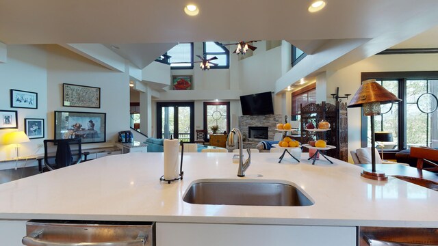 268 Little Oak Island Dr, Folly Beach, SC 29439 - kitchen with a wealth of natural light, sink, an island with sink, and a stone fireplace