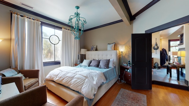 268 Little Oak Island Dr, Folly Beach, SC 29439 - bedroom featuring hardwood / wood-style floors, a chandelier, beamed ceiling, and multiple windows