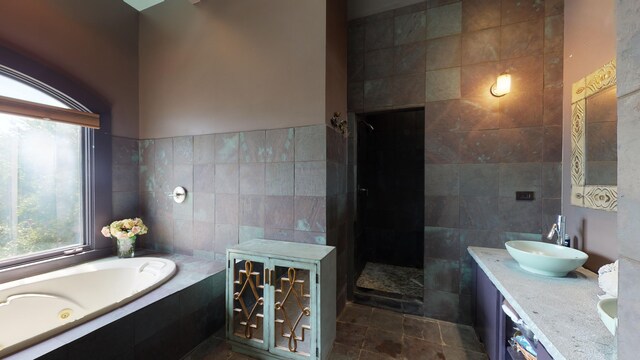 268 Little Oak Island Dr, Folly Beach, SC 29439 - bathroom featuring tile walls, tile patterned flooring, a relaxing tiled tub, and dual bowl vanity