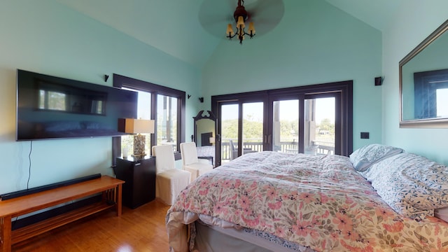 268 Little Oak Island Dr, Folly Beach, SC 29439 - bedroom with high vaulted ceiling, access to exterior, and wood-type flooring