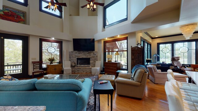 268 Little Oak Island Dr, Folly Beach, SC 29439 - living room with a fireplace, light hardwood / wood-style flooring, ceiling fan, and a healthy amount of sunlight