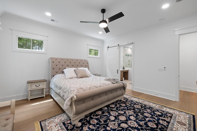 3226 Waverly Ln, Johns Island, SC 29455 - bedroom featuring a barn door, multiple windows, crown molding, wood finished floors, and recessed lighting