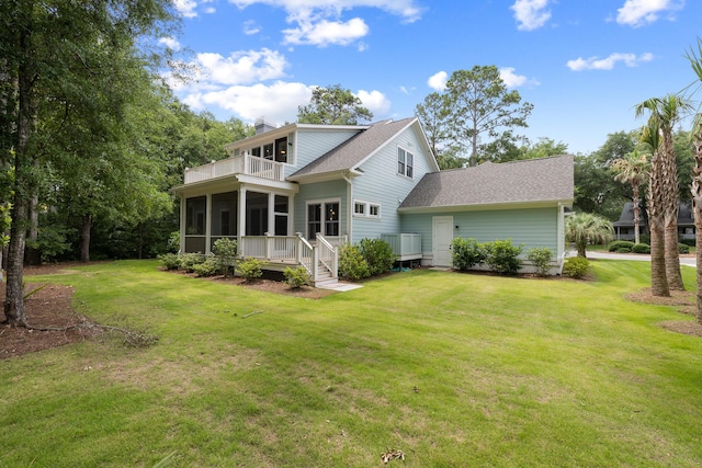 3226 Waverly Ln, Johns Island, SC 29455 - rear view of house with a balcony, a sunroom, a shingled roof, a chimney, and a lawn