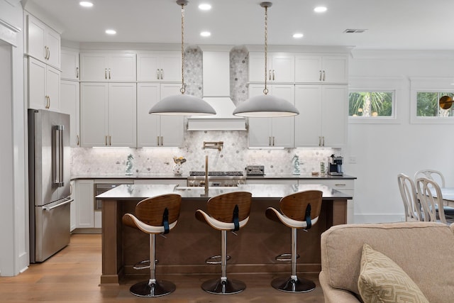 3226 Waverly Ln, Johns Island, SC 29455 - kitchen featuring high quality fridge, custom exhaust hood, tasteful backsplash, a kitchen bar, and recessed lighting