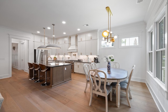 3226 Waverly Ln, Johns Island, SC 29455 - dining area with crown molding, light wood-style flooring, recessed lighting, and a chandelier