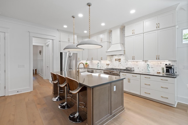 3226 Waverly Ln, Johns Island, SC 29455 - kitchen with high quality fridge, custom exhaust hood, light wood-style flooring, decorative backsplash, and recessed lighting