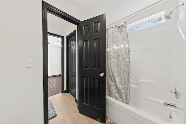 bathroom featuring tile patterned flooring and shower / bathtub combination with curtain