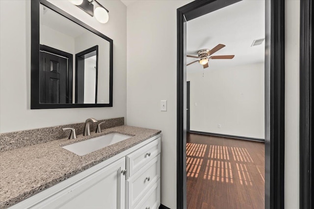 bathroom with vanity, wood finished floors, visible vents, and ceiling fan