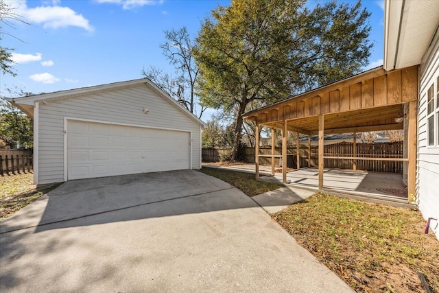 detached garage featuring fence