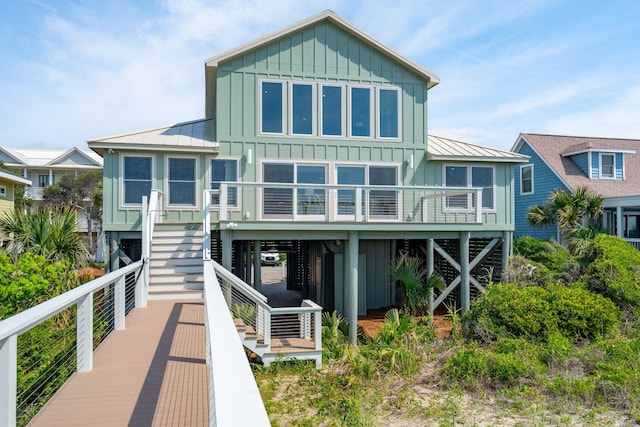 313 E Arctic Ave, Folly Beach, SC 29439 - back of property with board and batten siding, stairs, a standing seam roof, and metal roof