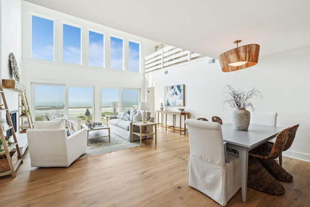 313 E Arctic Ave, Folly Beach, SC 29439 - dining area with light wood-style flooring and a high ceiling