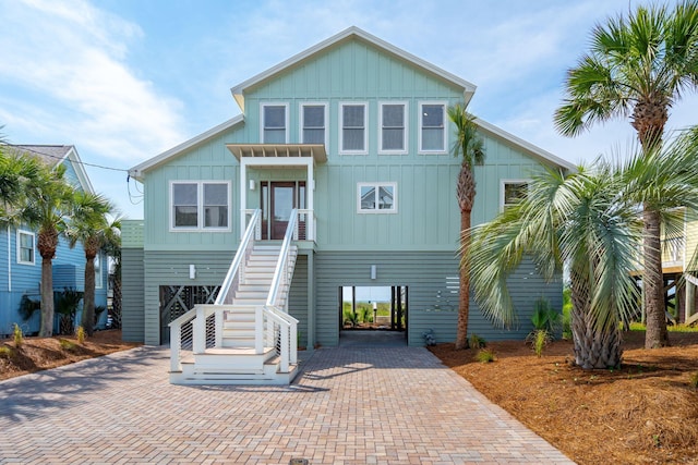 313 E Arctic Ave, Folly Beach, SC 29439 - beach home featuring board and batten siding, stairs, a carport, and decorative driveway