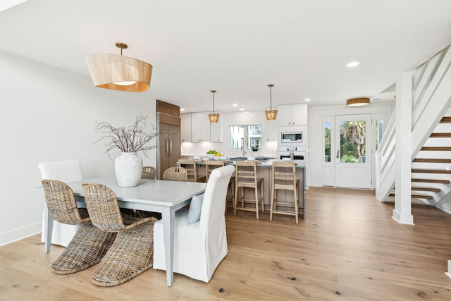 313 E Arctic Ave, Folly Beach, SC 29439 - dining area featuring light wood-type flooring, recessed lighting, stairs, and baseboards