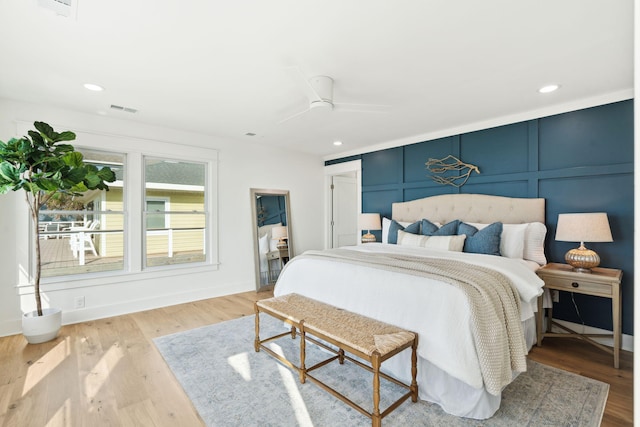 313 E Arctic Ave, Folly Beach, SC 29439 - bedroom with wood finished floors, a decorative wall, baseboards, ceiling fan, and recessed lighting