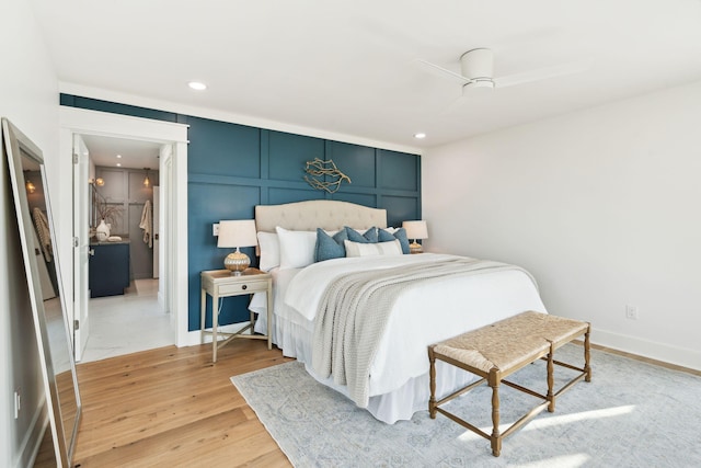 313 E Arctic Ave, Folly Beach, SC 29439 - bedroom with light wood-style floors, a decorative wall, recessed lighting, and baseboards
